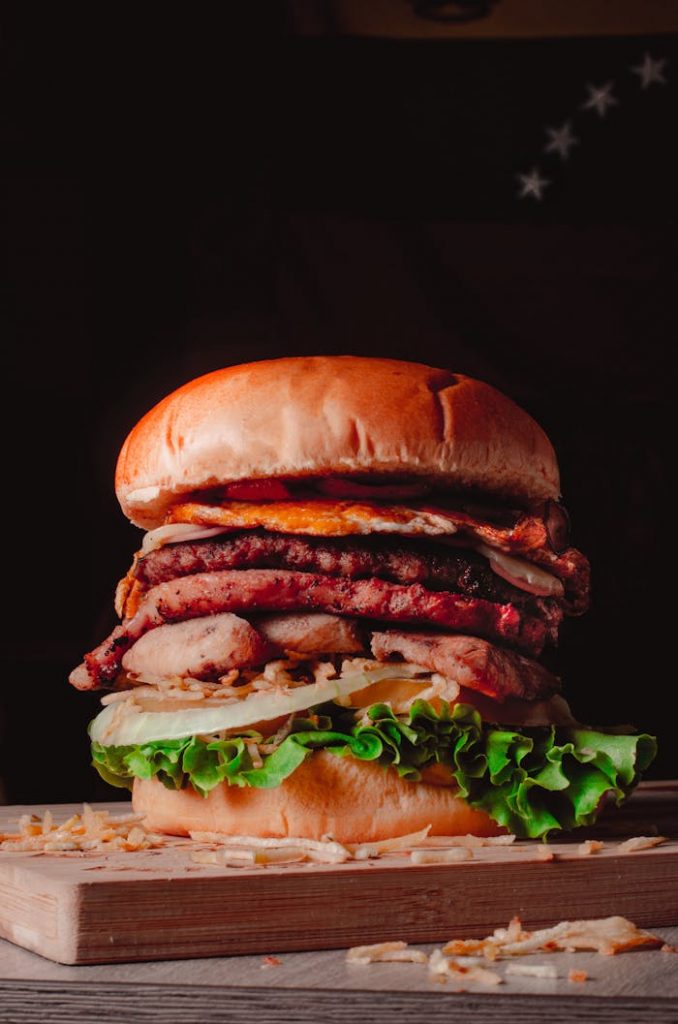 Mouth-watering gourmet burger stacked with fresh ingredients and savory meats.